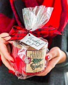 a woman holding a wrapped gift in her hands