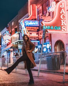 a woman walking down the street at night