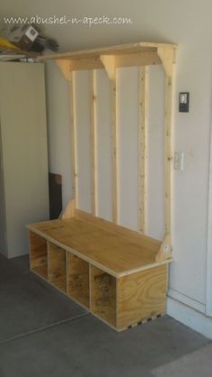 a bench made out of plywood is in the middle of a room with white walls