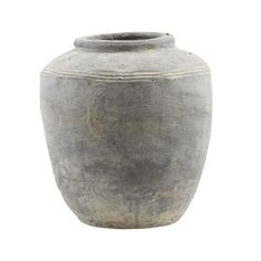 a large gray vase sitting on top of a white surface