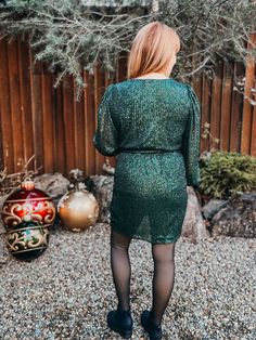 Step up your fashion game with our Higher Standards Dress! This long sleeve dress features a gorgeous green sequin design, complete with a flirty crossed v neck and waist tie for a flattering silhouette. Command attention in this playful and chic dress. Green Sequin Dress, Sequin Design, Standard Dress, Green Sequins, Weekend Sale, High Standards, Product Label, Green Velvet, Chic Dress