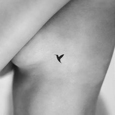 a small bird tattoo on the chest