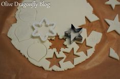 cookie cutters and star shaped cookies on top of a baking sheet with the words olive dragonfly blog