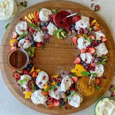 a fruit and cheese wreath on a wooden platter