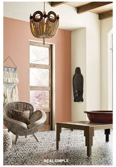 a living room filled with furniture and a chandelier hanging over it's windows