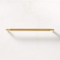 a gold pen sitting on top of a white surface