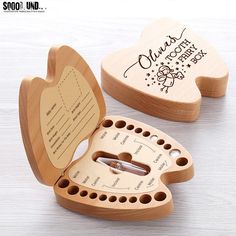 two wooden heart shaped boxes with holes in the middle and writing on each one side