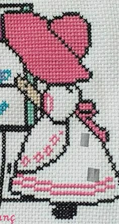 the cross stitch pattern shows a girl with a pink hat and dress