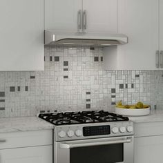 a stove top oven sitting inside of a kitchen next to a bowl of fruit on the counter