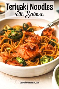 a bowl filled with teriyaki noodles and broccoli, topped with chicken