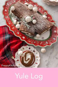 yule log cake on a red and green platter next to a cup of hot chocolate