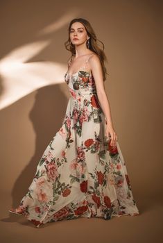 Reminiscent of an English garden in bloom is the Naaz Corset Long Dress from the Fall'23 Collection. Coming alive in the elegance of flowy viscose crinkle chiffon, this nude hued floral print maxi dress comes with an alluring corseted neck with detachable spaghetti straps. The maxi exhibits a gentle flow as it descends to its ankle-grazing length. An enchanting style for those garden parties! Made In India Nude Viscose Crinkle Chiffon Floral Print Shell -100% Viscose Lining- 100% Viscose Spaghet Corset Long Dress, Posh Dresses, Pink Academia, Italian Chic, Floral Chiffon Maxi Dress, Designer Maxi Dress, Fall 23, Chiffon Floral, Garden Parties