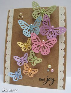 a close up of a greeting card with many butterflies on it and pearls in the middle