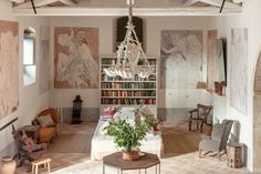 a living room filled with furniture and a fire place in front of a book shelf