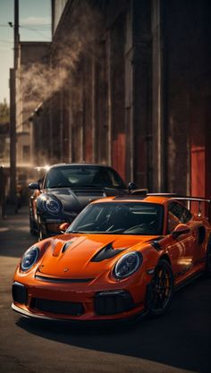 two orange sports cars parked on the street