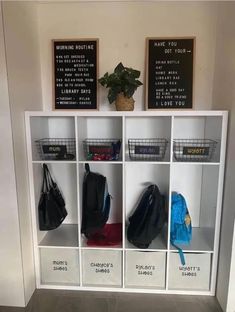 a white bookcase filled with lots of bags and purses on top of it