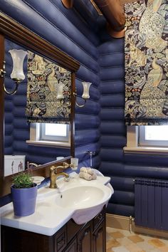 a bathroom with blue walls and wood trimmings on the ceiling, along with a white sink