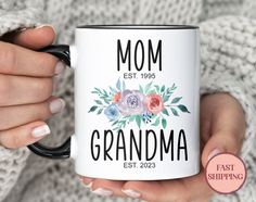 a woman holding a coffee mug that says, mom est 1950 grandma est 2003