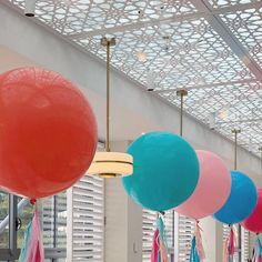 colorful balloons hanging from the ceiling in a room