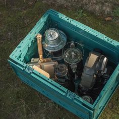 an open box filled with assorted items on the ground