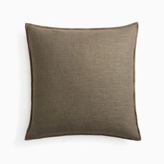 an olive green pillow with dark brown piping on the front and back, against a white background