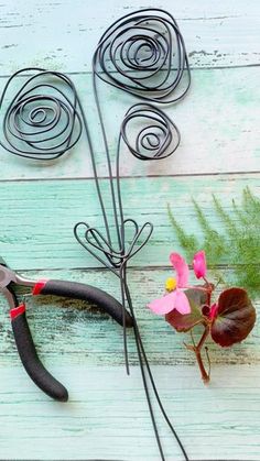 scissors and wire flowers on a wooden table