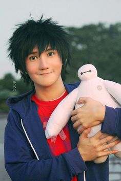 a person holding a stuffed animal in their arms