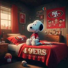 a snoopy dog sitting on top of a bed in a bedroom with a football jersey