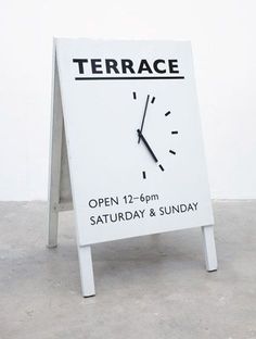 a sign with a clock on it that says terrace open 11 - 9pm saturday and sunday