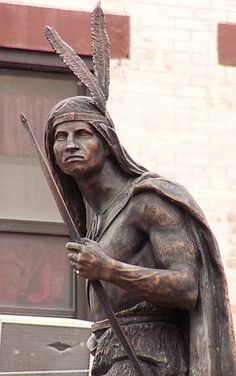 a statue of a native american holding a spear