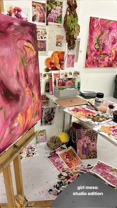 an artist's studio with paintings on easel