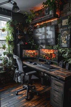 two computer monitors sitting on top of a wooden desk