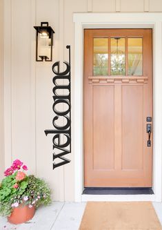 a welcome sign on the front door of a house