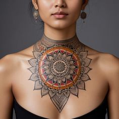 a woman wearing a black top with an intricate design on her chest and neck piece