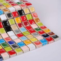 a multicolored glass tile design on a white background