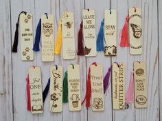 wooden bookmarks with tassels and writing on them