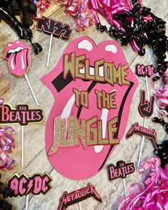 the rolling stones'welcome to the jungle sign surrounded by lollipop stickers