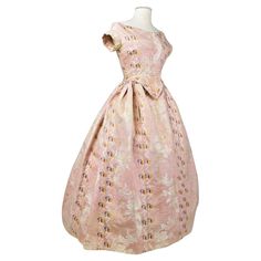 Circa 1860 France or Southern Europe Beautiful summer crinoline ball gown in pale pink moiré silk lampas with brocaded floral garlands, probably made earlier than the large crinoline dress. The one-piece bodice is whalebone, pointed at the front and fastened with period brass hooks at the back. The skirt is finely mounted in organza pleats and sewn to the bodice. Cream chintz lining and side slits for pockets. The dress has a few tiny halos on the front skirt, which are very difficult to see, and tiny halos under the arms. The lampas is very strong, with no holes or major flaws. Good overall condition in terms of colour and conservation. Dimensions: Equivalent to size 36/38 France. Height 122 cm, shoulders 36 cm, chest 90 cm, waist 70 cm, skirt 300 cm. Organza Pleats, Crinoline Dress, Romantic Era, Brass Hooks, Rose Pale, Southern Europe, Floral Garland, Dreamy Dress, 50 Fashion