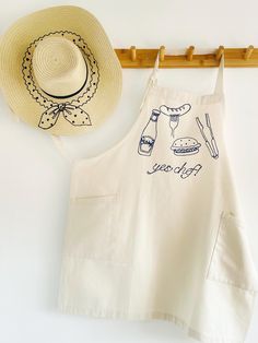 an apron and hat hanging on a wall