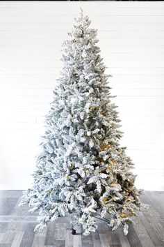 a white christmas tree with snow on it