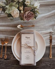 a table setting with flowers and silverware