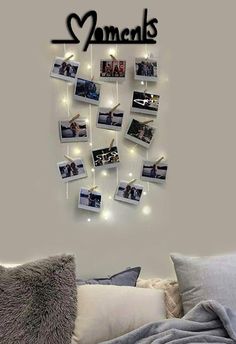 there is a bed with pictures on the wall and lights above it that read, moms