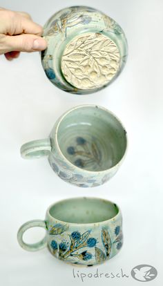 two handmade mugs being thrown into the air