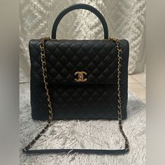 Chanel Top Handle Bag Vintage 2016, Worn Only A Handful Times In Amazing Condition Just A Few Little Scratches Inside Flap Black Leather Caviar Interlocking Cc Logo & Quilted Stitching Brushed Gold Hardware Rolled Handle & Chain-Link Shoulder Strap Twill Lining & Four Interior Pockets Turn-Lock Closure At Front Protective Feet At Base Includes Box & Dust Bag Can Be Worn Crossbody As I Wore, Shoulder Strap Or By Top Handle Authenticated Shoulder Strap Drop: 28” Handle Drop: 3.25" Height: 10" Width: 12.5" Depth: 4.5" Chanel Top Handle Bag, Chanel Top Handle, Chanel Top, Brushed Gold Hardware, Coco Handle, Quilt Stitching, Bag Vintage, Cc Logo, Handle Bag