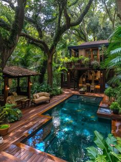 an outdoor swimming pool surrounded by trees and plants