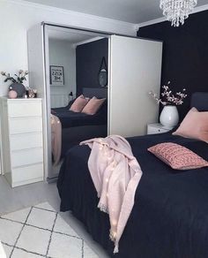 a bedroom with two beds and a chandelier