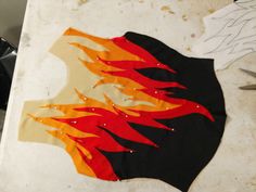 a piece of paper with fire painted on it