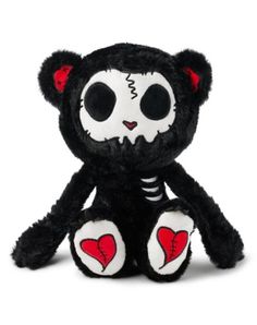 a black and white stuffed animal with red hearts