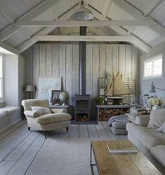 a living room filled with furniture and a fire place in the middle of a room