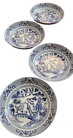 three blue and white plates sitting next to each other